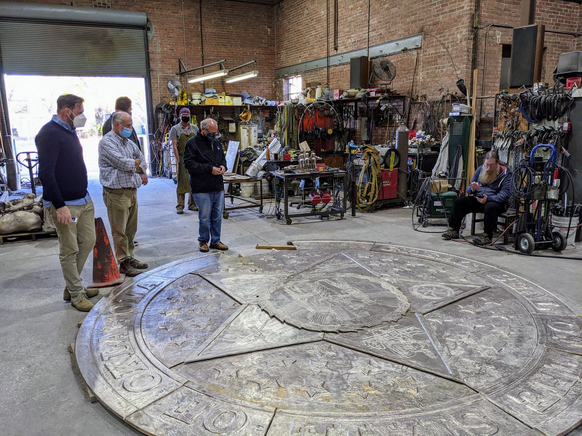 OKStateCapitol's tweet photo. Our team took a field trip to The Crucible in Norman yesterday to check out progress on the new bronze state seal slated for installation in the ground floor rotunda early next year. The seal is 14 feet in diameter and weighs about 3,000 pounds. https://t.co/GgvAW30F2Q