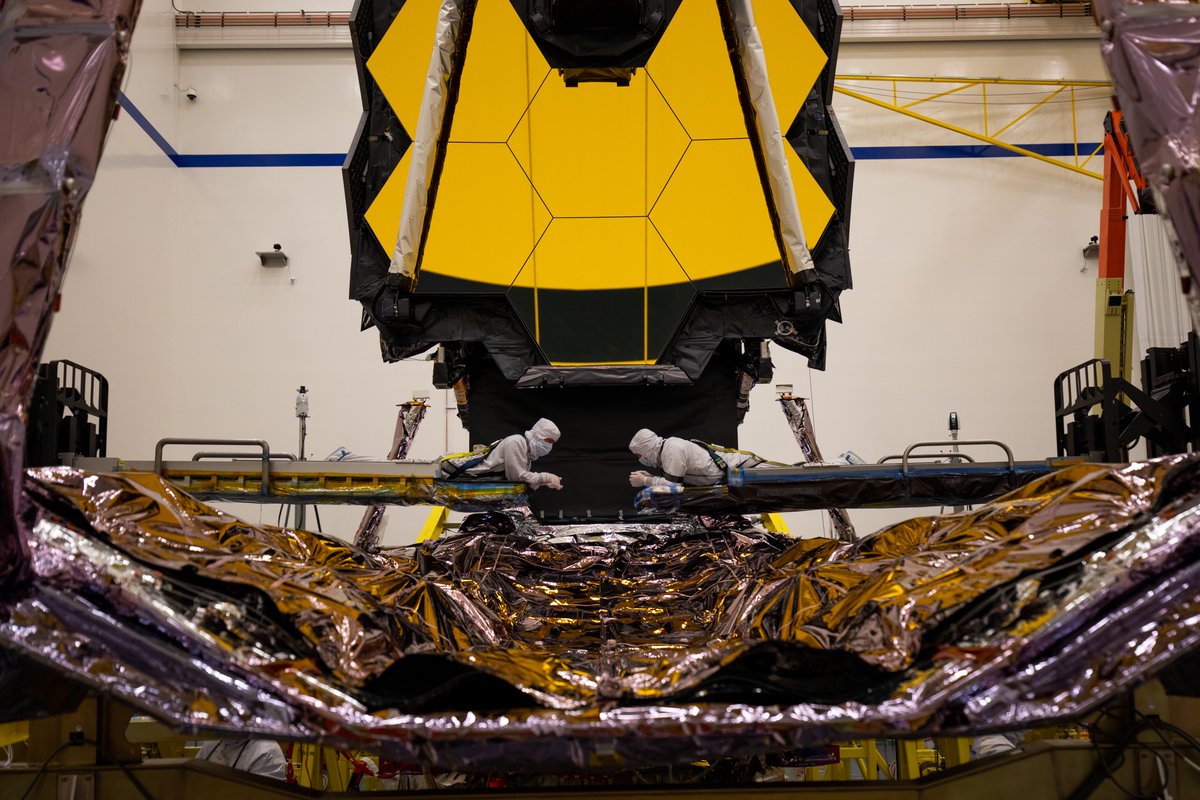Technicians inspect a critical part of the James Webb Space Telescope known as the Deployable Tower Assembly after fully extending it in the same maneuver it will perform in once in space. Credit: Northrop Grumman