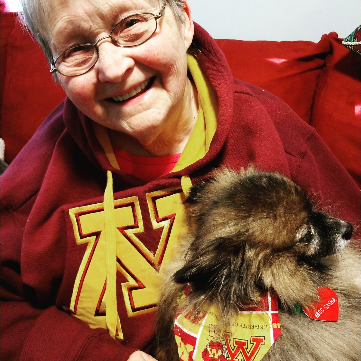 EchoFPayne's tweet photo. We've got a lot of #umnpride in this household! We're all UMN alumni/students. Here's my aunt Marie Milsten Fiedler and her dog Sasha telling you to help support students when they're facing emergencies by giving at https://t.co/XfQbgSKweu 
#umngive #cfansproud https://t.co/nv59XMwx2N
