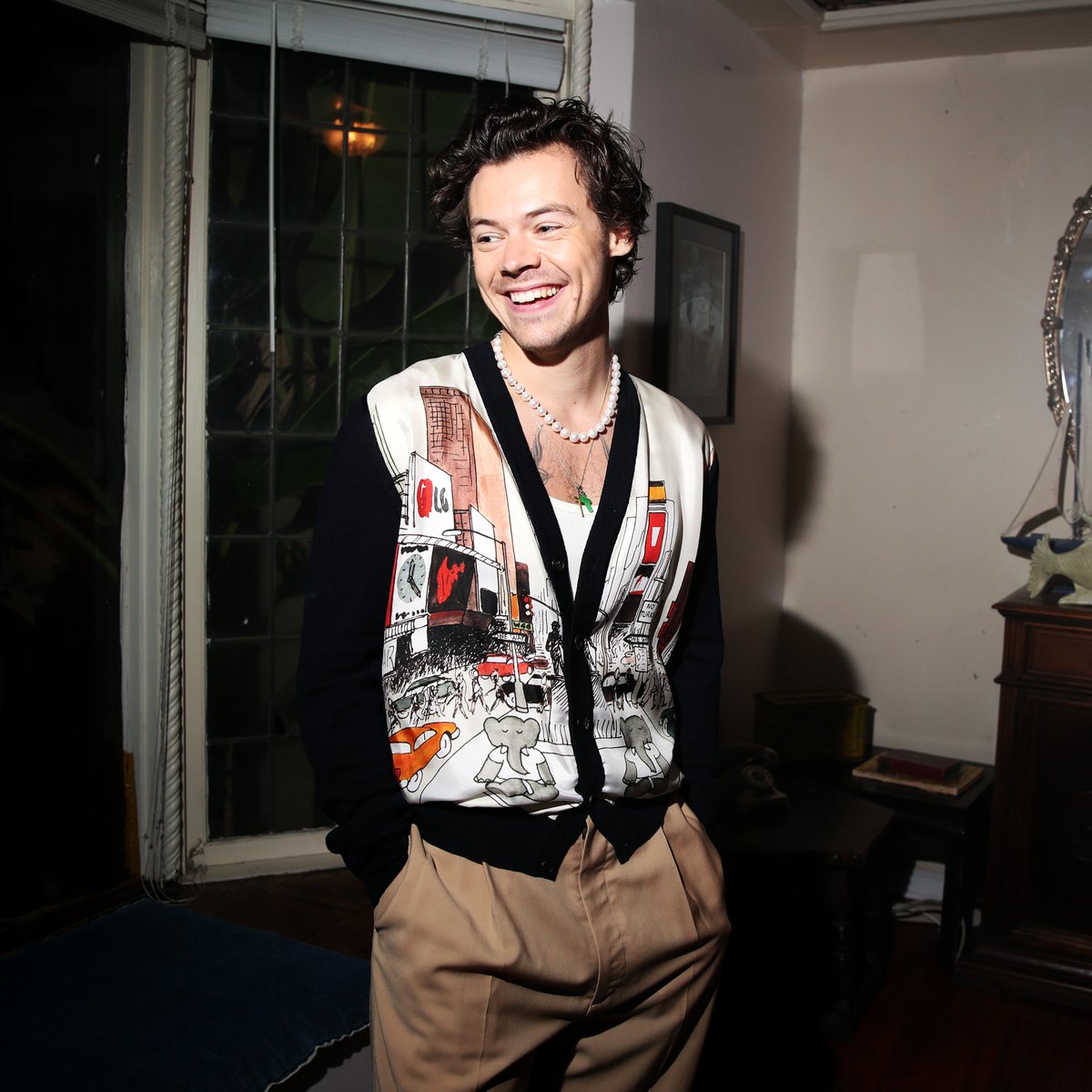 Harry Styles can do classic just as well as showman, seen clearly here in this Lanvin cardigan, muted slacks, and Old Skool vans with his signature pearl necklace, duh!