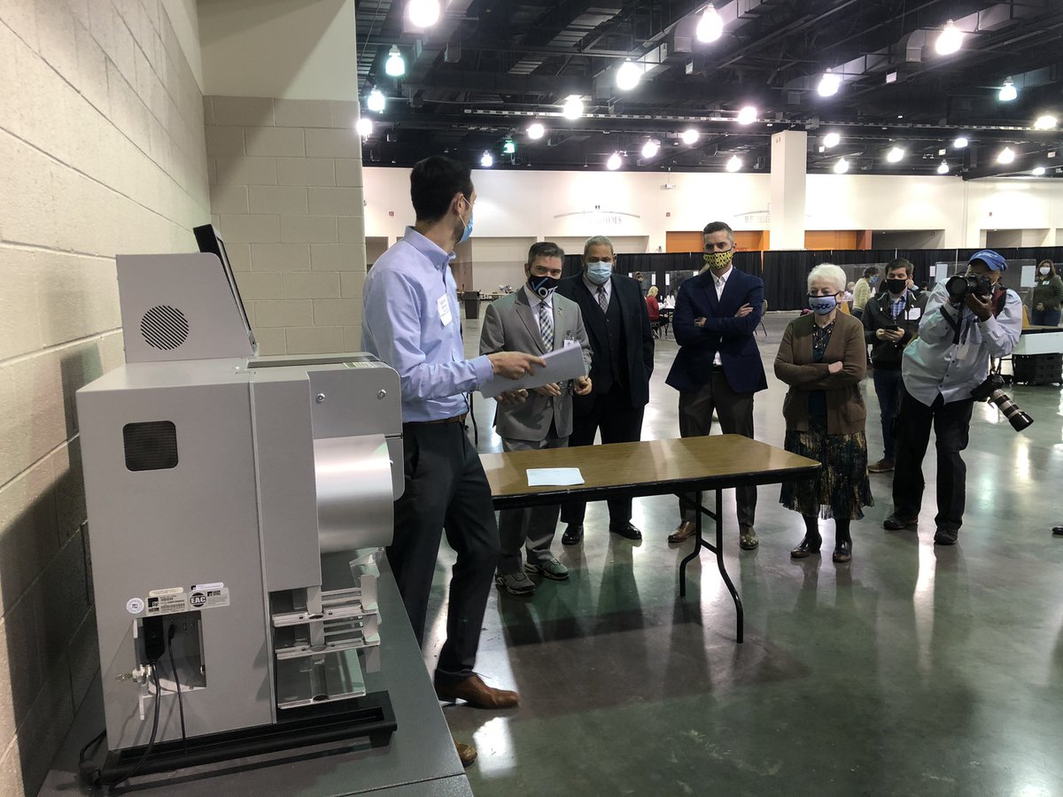 One of five DS-850 counting machines being audited by provider ES&S in presence of election commission before recount can begin. Republican commissioner Rick Baas asks to review ballots before processing