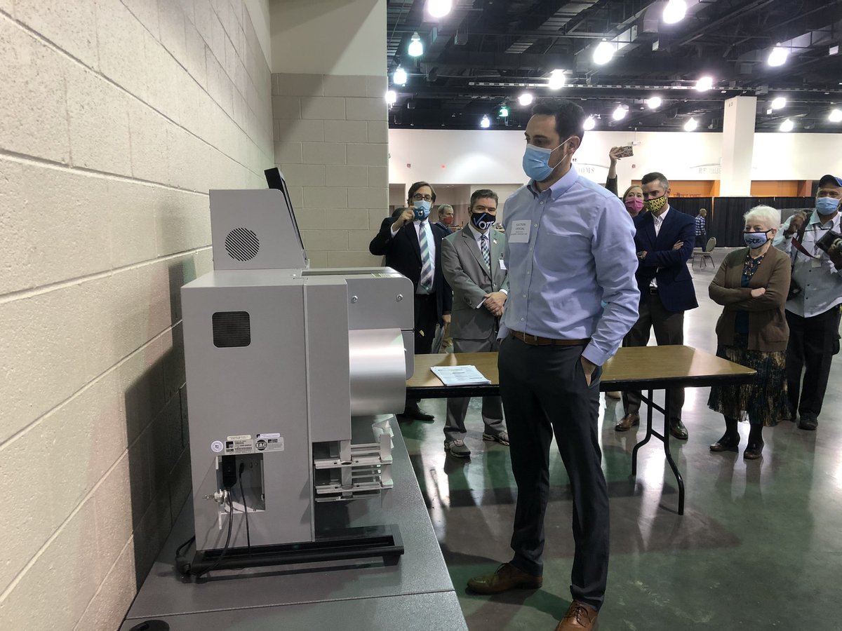 One of five DS-850 counting machines being audited by provider ES&S in presence of election commission before recount can begin. Republican commissioner Rick Baas asks to review ballots before processing