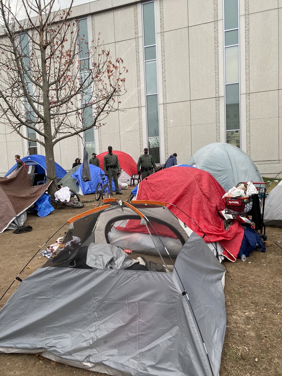 sayleskasten's tweet photo. 15 State troopers surprise evicting 30+ homeless people in Manchester, without giving them places they can go. @GovChrisSununu is this how you treat the most vulnerable? #StopTheEvictions https://t.co/D4tT2ie2s7