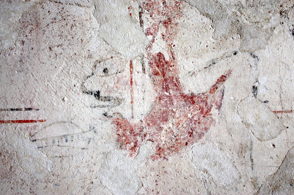 Behind the saint are vestiges of a bow, hand and arrow: the bow outlined in black; the arrow and hand in red. Facing him are the remains of two hooded figures in profile, the nearest is shooting another arrow.