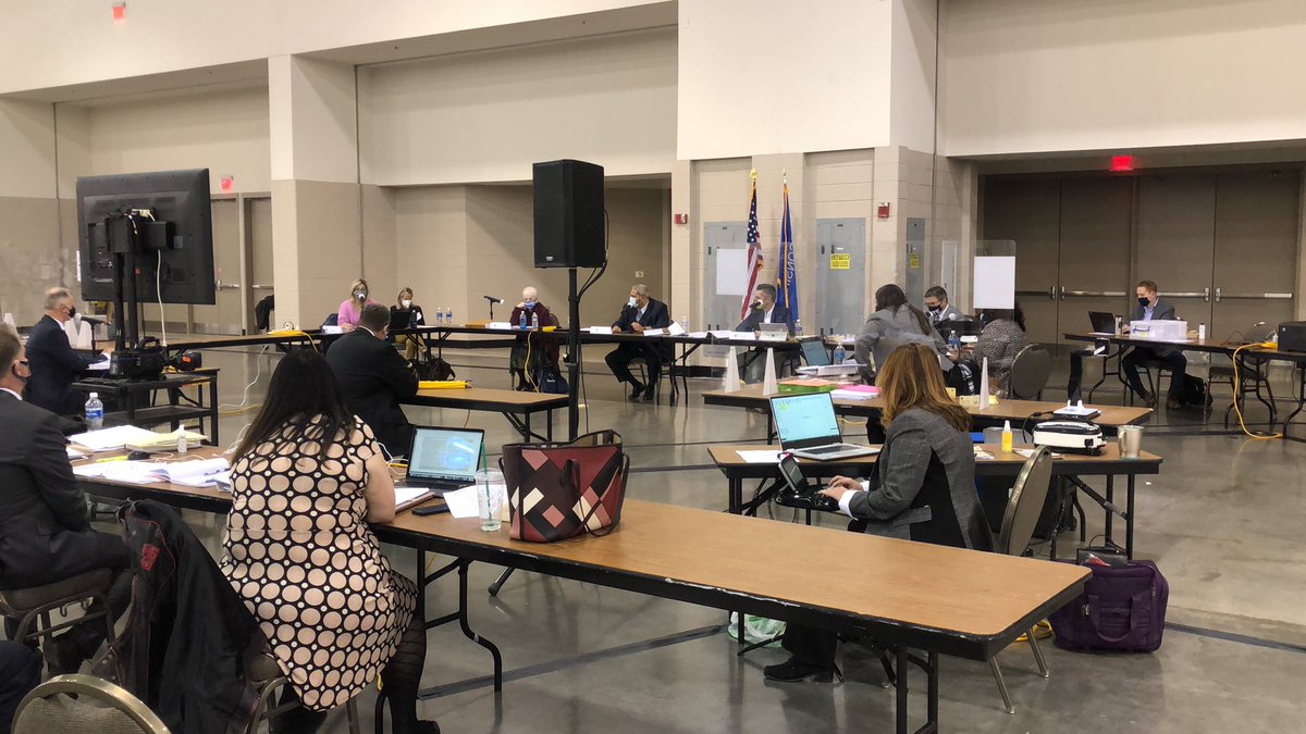 Trump observer triggers challenge on city of Milwaukee curbside vote envelope. Poll worker raises hand to get guidance. ED Claire Woodall-Vogg brings it to commission to settle issue.