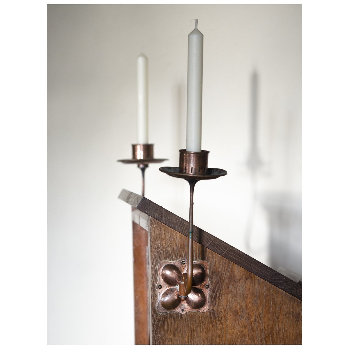 He also refitted the chapel with simple Arts and Crafts furnishings - possibly a new altar table, definitely the communion rail, stalls, and a slightly grand lectern probably standing in for a pulpit. This has lovely slender copper candleholders with repousse work.