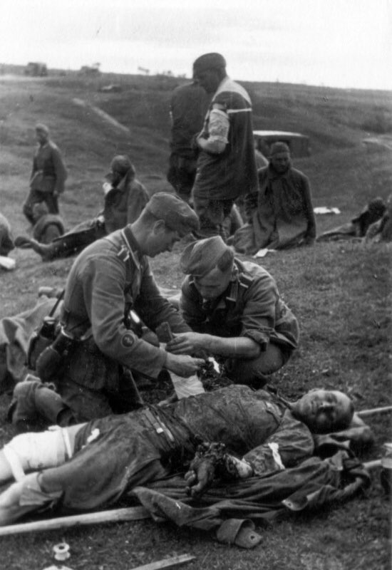 Pic 2 & 3 - Left Sanitasche & contents. Worn on the belt in place of K98 ammo pouches. Typically a Sani wore a sidearm for protection of himself & his patients. Note the tourniquet & dressings as used on the stretcher casualty. 51d)