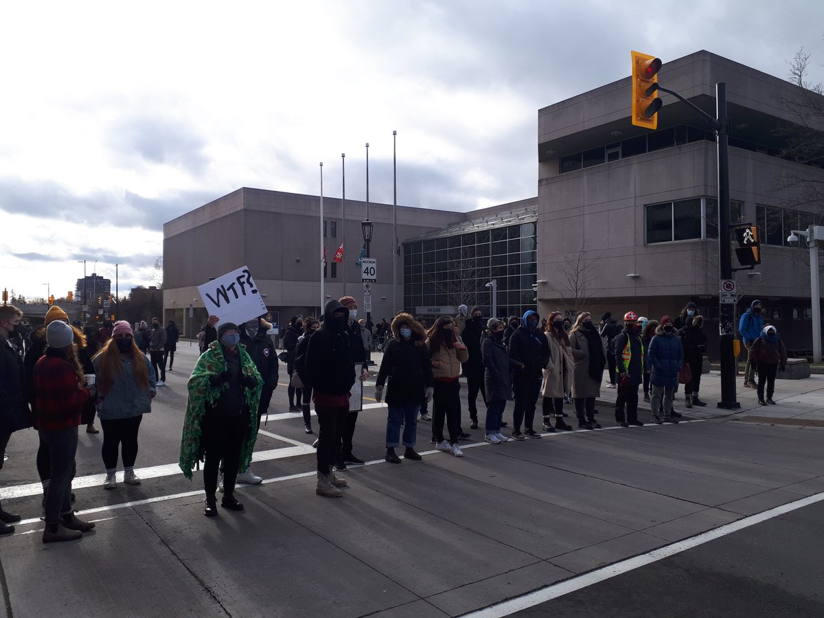 PBIcanada's tweet photo. About 100 people are chanting "Black lives matter, respect Indigenous sovereignty" on the street outside the Ottawa police station after 12 BIPOC defenders were arrested at a protest in the early hours of this morning. They are starting to be released now. "Free them all!" https://t.co/069LfDw8gS