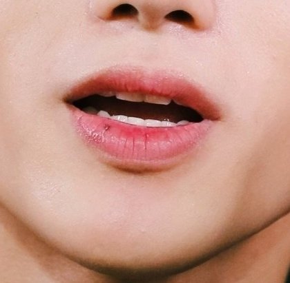 wooyoung (ateez) and the moles under his left eye and on his lower lipalso: small scars including twin ones on his cheek