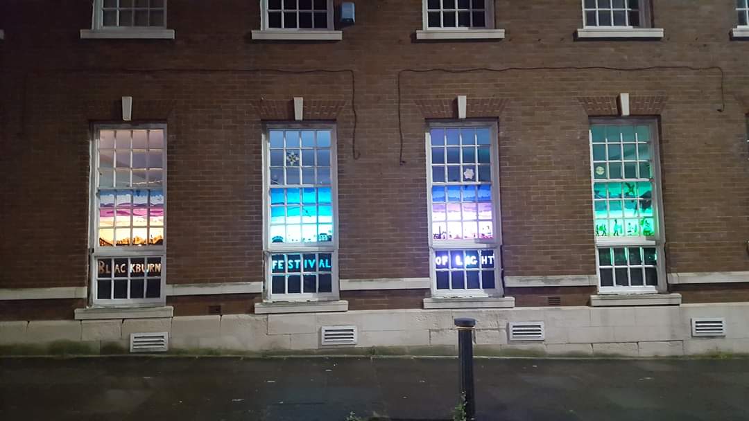 BureauBlackburn's tweet image. It&apos;s the @BBFestofLight Festival @ Home tonight. We love sharing a building with the festival and they&apos;ve brought colour and joy to our windows for the festival. @Blackburn_BID