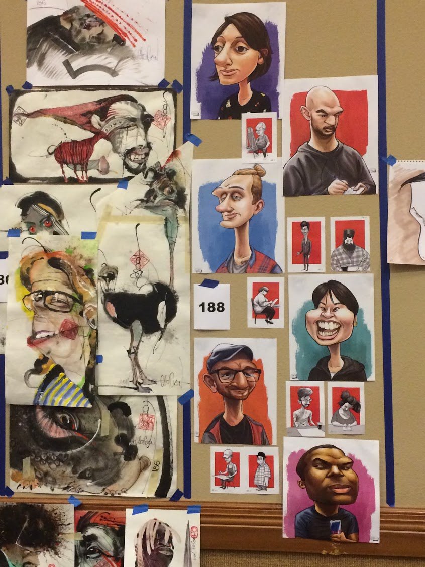 I tried my very best, doing digital illustrated caricatures, and posted my work on the wall in my designated spot. We each had a numbered space. Mine (on the right, 188), was positioned next to an unbelievable artist whose work dwarfed mine in both artistry and quantity.