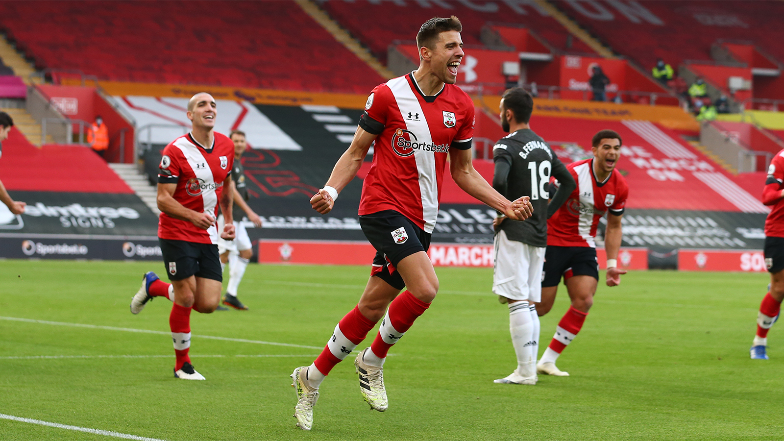 Jan Bednarek runs away celebrating after scoring.