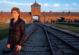 damian_thirsty's tweet photo. @AgentP22 that looks like the same sort of pose that Sturgeon did for the Natz Onal at Auschwitz . #nipolean is clearly "grooming" young Kate & not just for a role in the SNP it would seem 😉 https://t.co/l0fgJa0Ncy