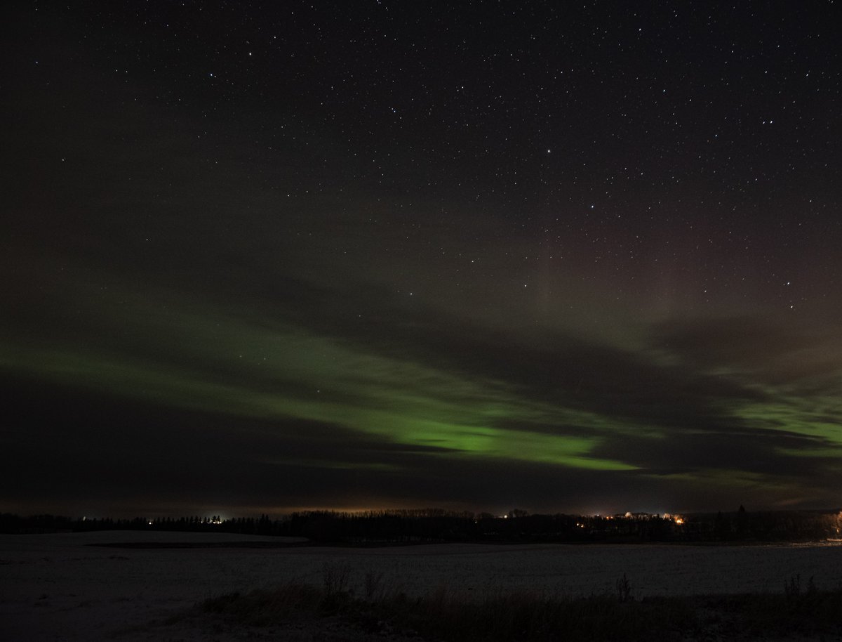 Further east and 50 minutes earlier,  #Suomi-NPP captured this view from above while  @dmaluk1 caught a glimpse of the  #NorthernLights through the clouds in Sandy Lake  #Manitoba and  @KimHinesSN captured a frosty  #backofcamera  #aurora shot from  #Winnipeg.