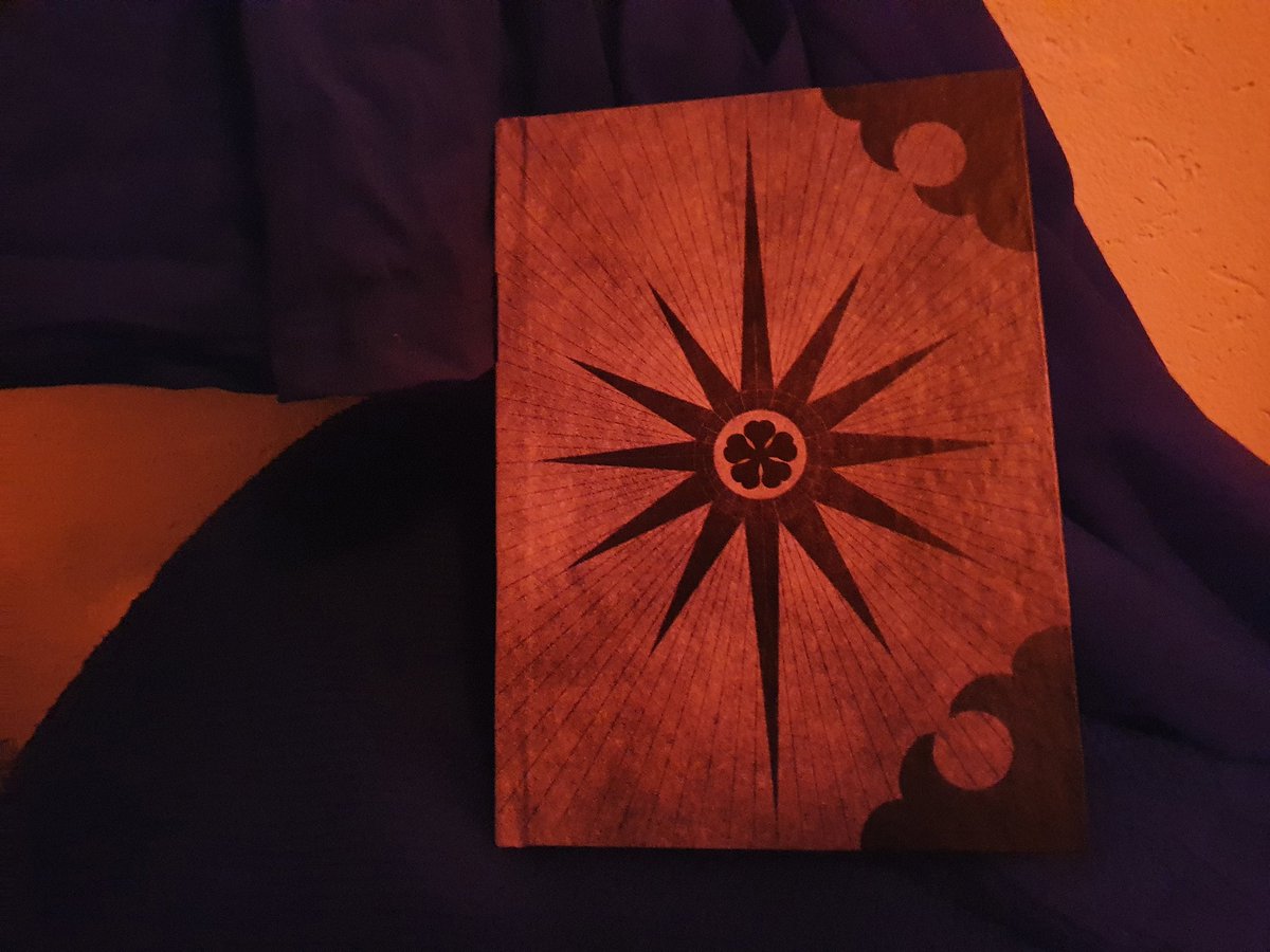 blackclovertalk's tweet photo. Just got this Patry's five leaf grimoire from @Blonya , which marks my first Black Clover merch! Surely many more to come.  (Tried to give it an ominous feeling from boredom, proper pictures in the comments) https://t.co/iiODuJBtSz
