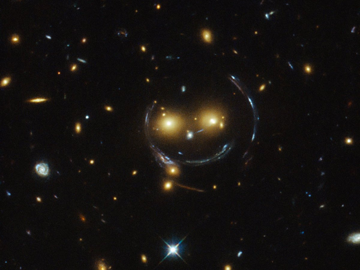 One way we “see” evidence for dark matter is through a phenomenon called gravitational lensing, which we can actually see in this NASA/ESA image taken with the Hubble Space Telescope. Some of what we see here isn’t real! What? https://www.nasa.gov/content/hubble-sees-a-smiling-lens