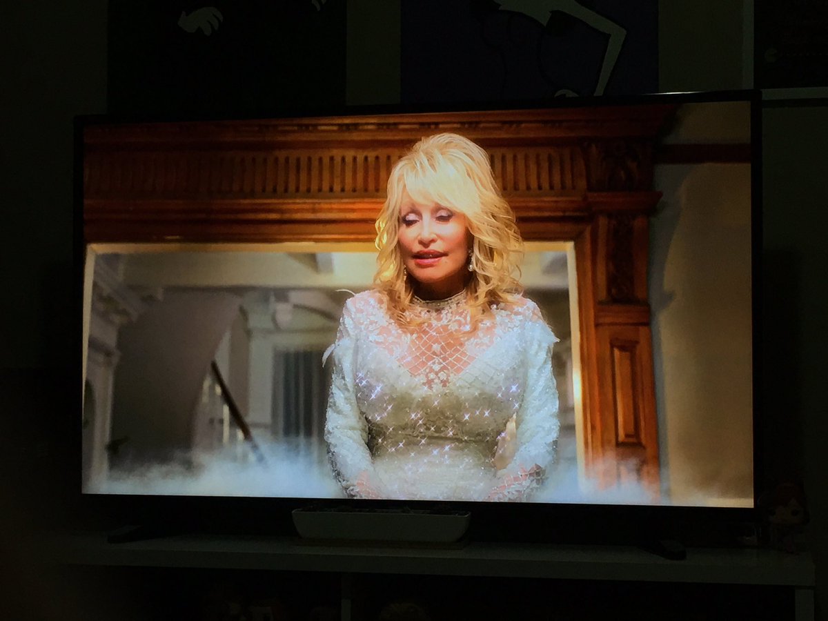 if you were wondering whether this movie has Dolly Parton perched on a cloud in Christine Baranski’s living room and singing the moral of the story at her, it absolutely does