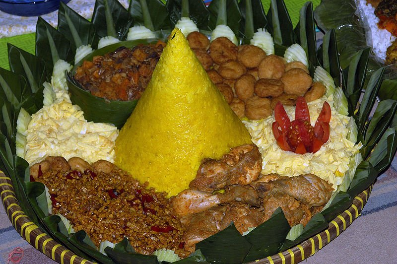 Javanese CuisineTumpeng is a yellow rice dish in the center with eggs, chicken, beef liver,potato, and tempeh onek on the side.