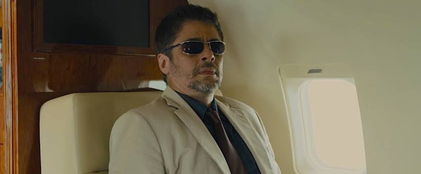 Alejandro (Benicio Del Toro) is the most interesting character in my opinion. He is introduced in a beige suit like Matt, but underneath it he wears a dark shirt; hinting his dark past and nature.