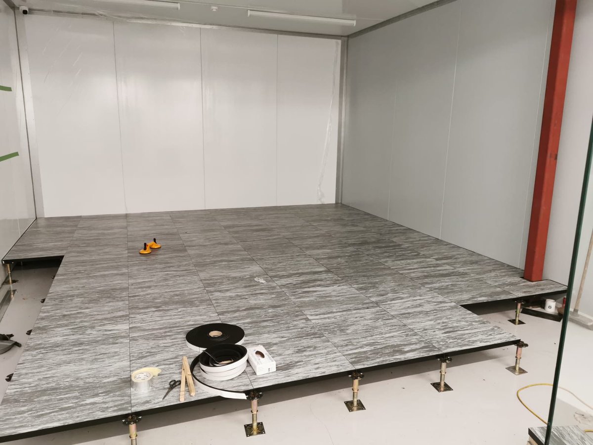 SafehostsDC's tweet photo. We love a good raised floor, and not just for server rooms. We're laying this raised access flooring in our new NOC to ensure all cabling is out of sight and we can easily reconfigure seating arrangements as per changing Government guidelines. #raisedflooring #safeworking https://t.co/guGiVvydId