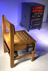 Chair sculpture by Steve Mann, exhibited at San Francisco Art Institute, 2001, comprises spikes that retract when a credit card is inserted to download a seating license.