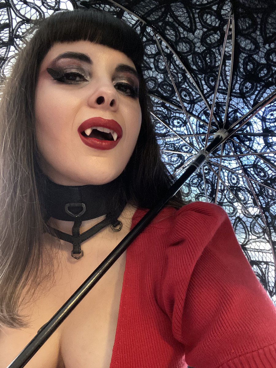 Kristy being extra with a parasol and fangs.