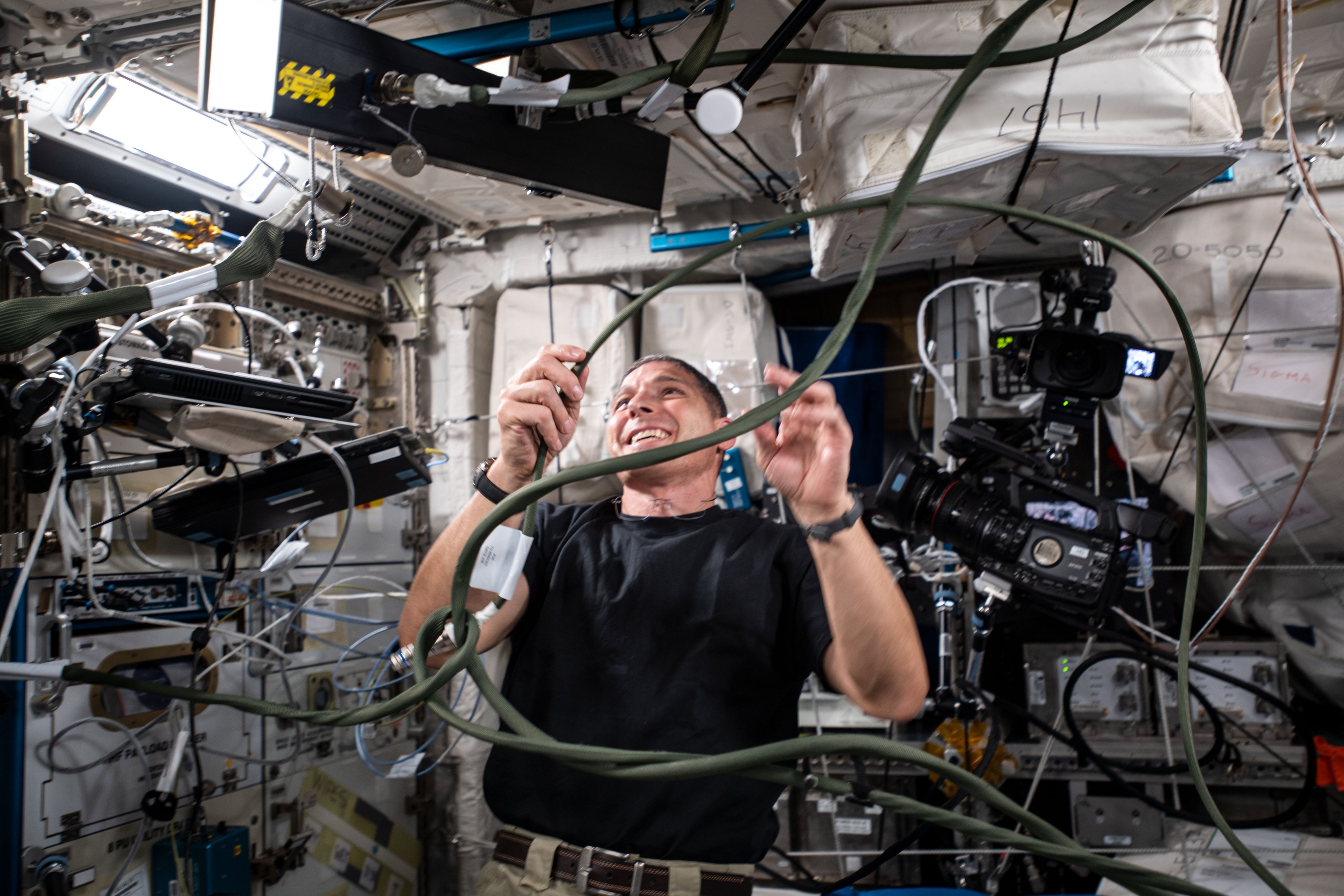 SpaceX Crew-1 Commander and Expedition 64 Flight Engineer Michael Hopkins of NASA sets up hardware for the Grip study that is researching how an astronaut's dexterous manipulation is affected by microgravity.