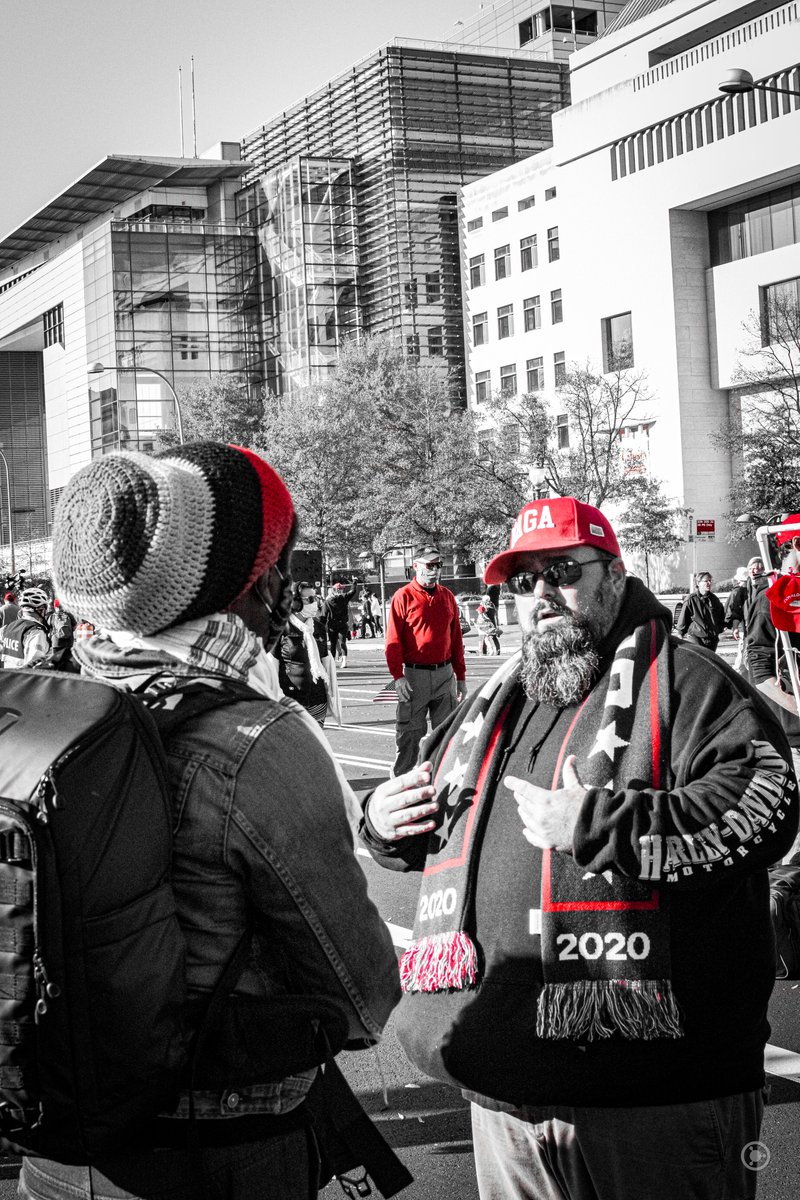 Smaller arguments bloomed, with this guy in a Harley Davidson hoodie complaining to a Black guy in a Rasta hat."Those BLM go through and destroy cities!" he cried, "we're just protesting peacefully!""By ripping other people's signs from their hands." the Black man countered.