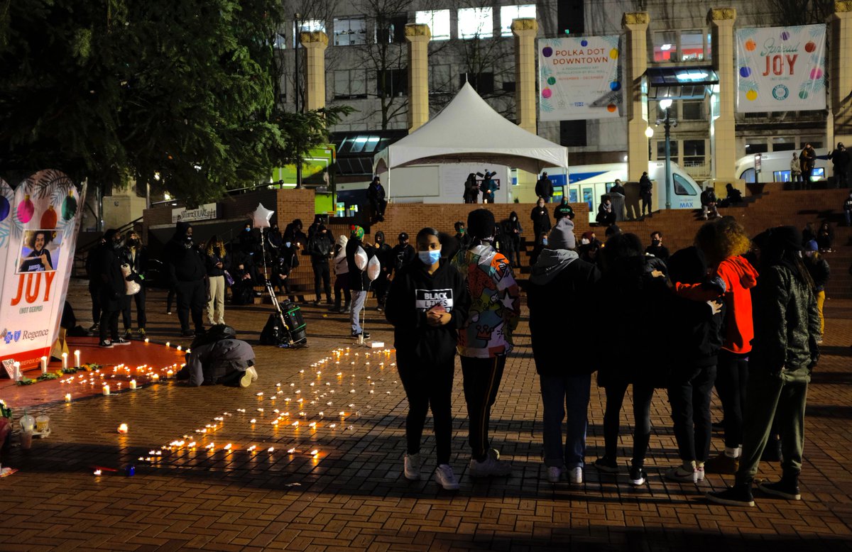 A candlelight vigil for TravisNagdy at Pioneer Courthouse Square in Downtown Portland. The friends and family of Hamza "Travis" Nagdy were in attendance and shared their memories. Candles are placed in front of the Christmas tree in the middle of the square. Another series of candles are placed to spell out "Travis" while many mourn and fill up the square and sit along the steps near the food trucks. 