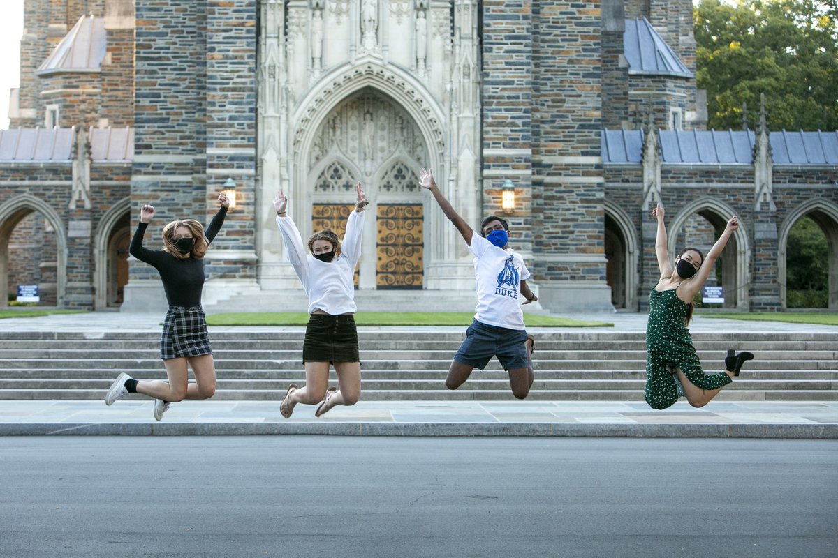 Four first-year students do a High School Musical pose in front of Duke Chapel during an early Fall afternoon.