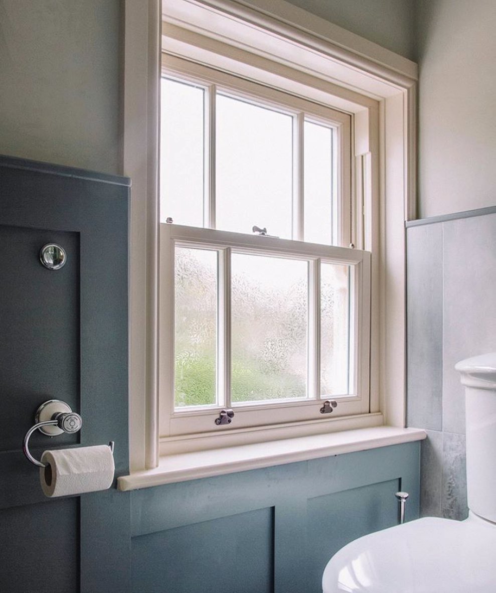 The view from the loo! #RoseCollection sash windows with patterned glass in this lovely panelled bathroom 👏