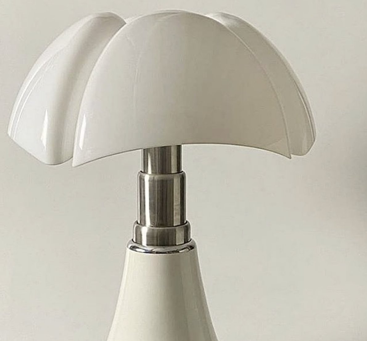 Cue the "Pipistrello"Now one of her more famous pieces, this oversized table lamp uses the amorphous shapes of art nouveau in its lampshade modernized with its material (plastic), and paired back with the traditional base