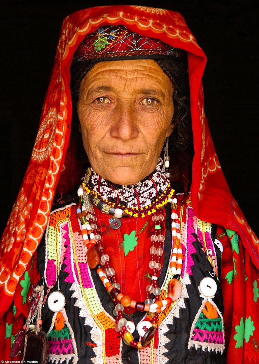 People of Wakhân: A Wakhi woman dressed in a brightly coloured red garment, marked with a myriad of patterns and textures represents the inhabitants of the Wakhan Corridor in northeastern Afghanistan.By Alexander Khimushin.