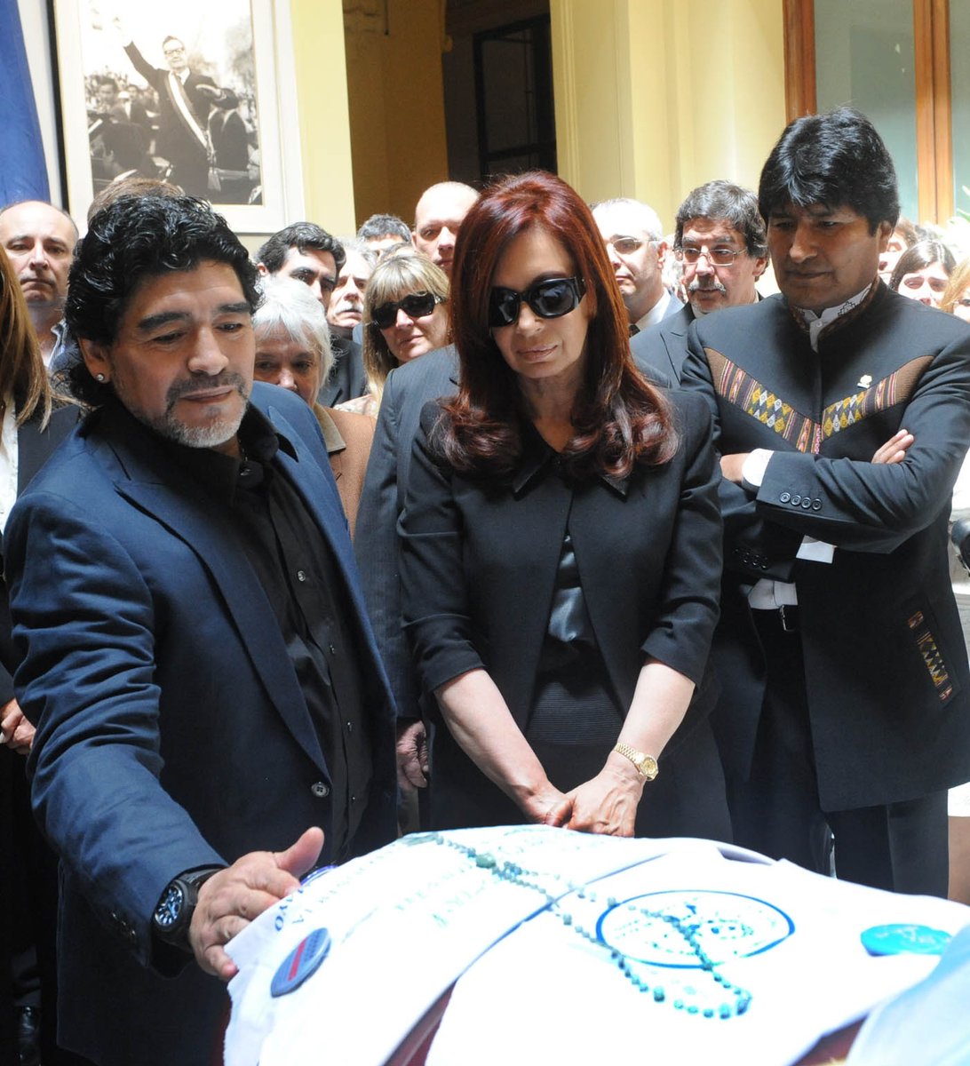 Maradona strongly supported the wave of leftist govts in Latin America—the "Pink Tide"Here he is in 2010 at funeral of Argentina's left-wing President Néstor Kirchner, with his wife (future president) Cristina and Bolivia's Evo MoralesPortrait of Chile's Allende in background