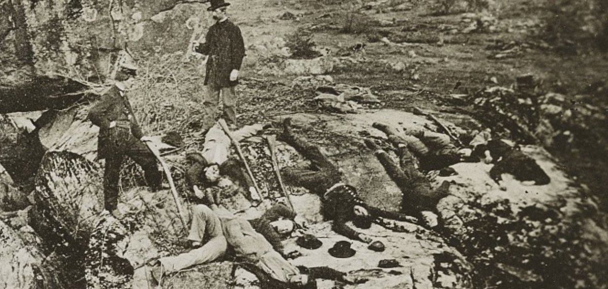 Most ambitiously, when Peter Weaver photographed Gettysburg four months later, he brought along a dozen living soldiers to play dead. After this photo was taken, every man shown here got up and walked away. The two standing are doctors who operated an embalming firm.