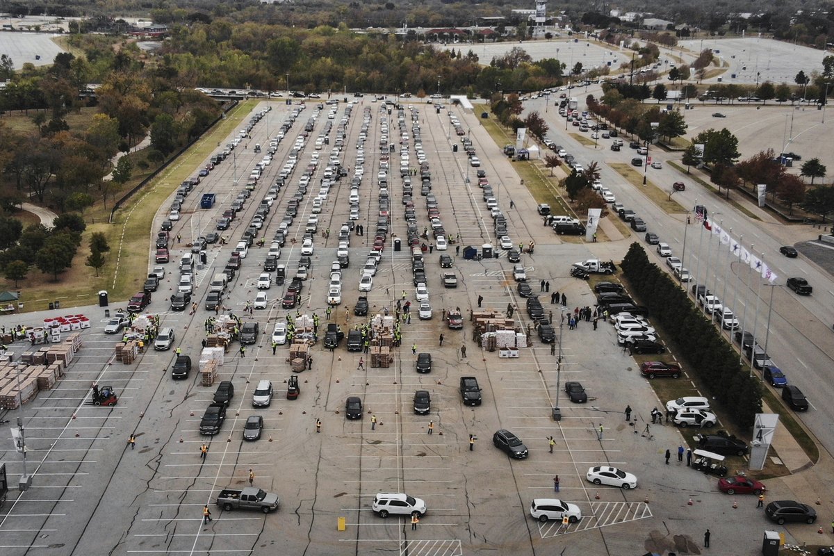 People line up in their cars to receive Thanksgiving meal boxes from the Tarrant Area Food Bank on Friday at an AT&T Stadium parking lot in Arlington, Texas. The food giveaway was the largest in the organization's history.  Yffy Yossifor / Star-Telegram / AP