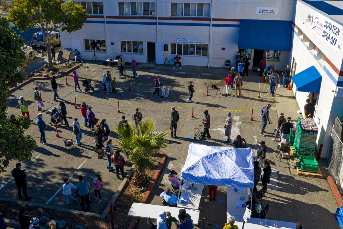 People wait in line to receive food at the Bay Area Rescue Mission's Thanksgiving Giveaway in Richmond, California on Tuesday. David Paul Morris / Bloomberg / Getty