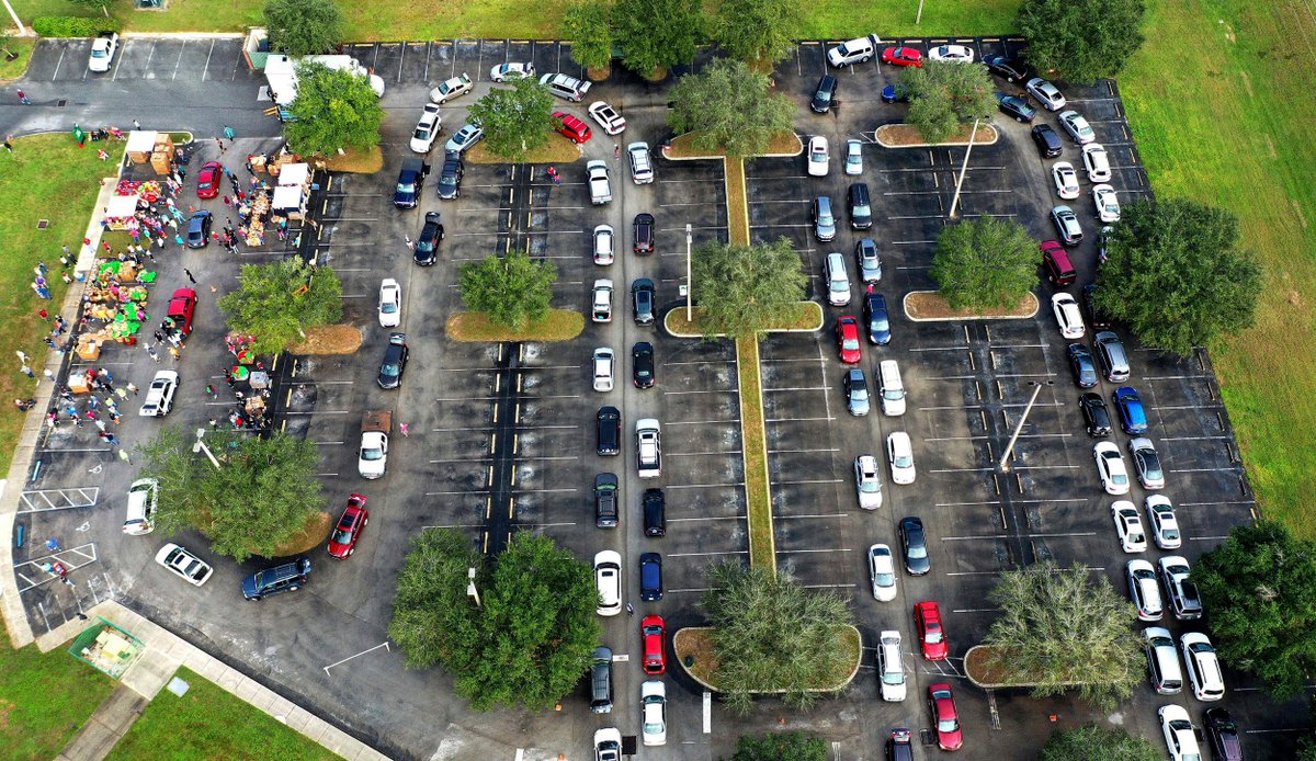Residents line up in their cars at a food distribution site at Lake-Sumter State College sponsored by the Second Harvest Food Bank of Central Florida and local churches in Clermont, Florida. Paul Hennessy / AP