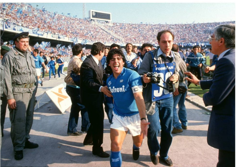 Ankaman616's tweet photo. It's this photo of Maradona, after Napoli win their first Serie A title in 1987, for me. https://t.co/Ip6opK6AXf