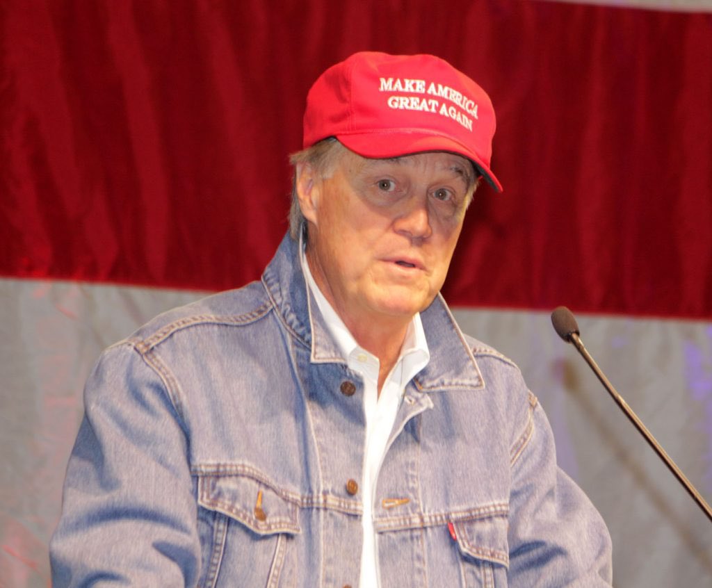 This may be the only time David Perdue has publicly worn a Trump MAGA hat.