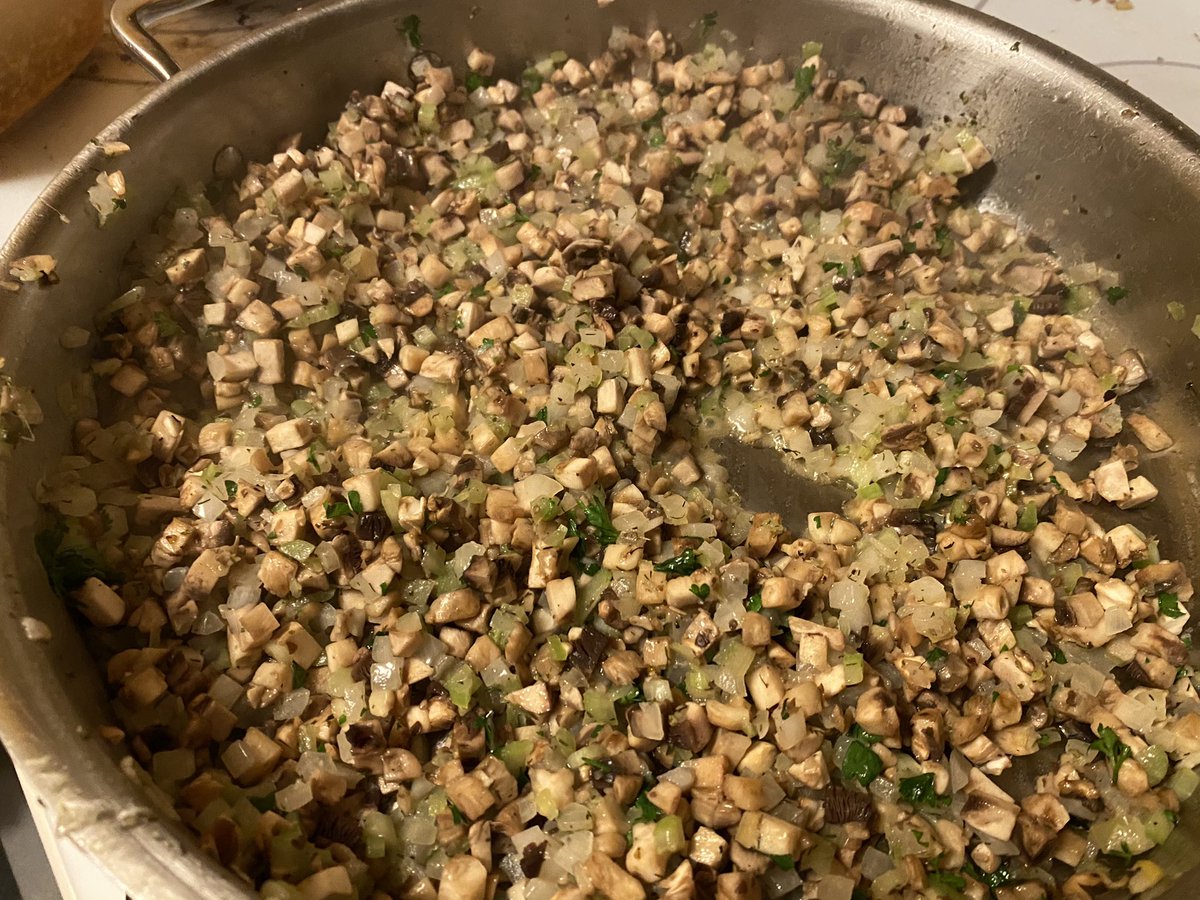 Okay so I have prepped 25 pounds of vegetables and made two trays of stuffing and the turkey is brining and now it’s onto rolls and cornbread This is mushroom onion stuffing mix with parsley and celeryThere’s squash caramelizing in the ovenThings are good