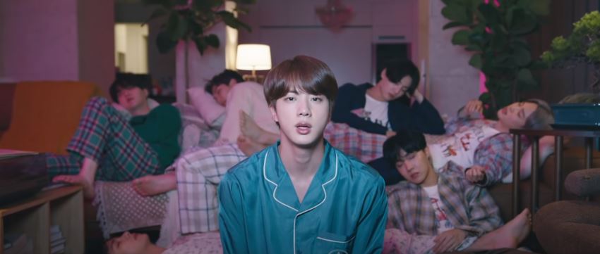 Going back, in the OG, we have a shot of them just watching the TV. (In FTMR we hear something about the virus on Hobi's verse in the bg, going from right ear to left). Everyone else falls asleep, and Jin reminisces.