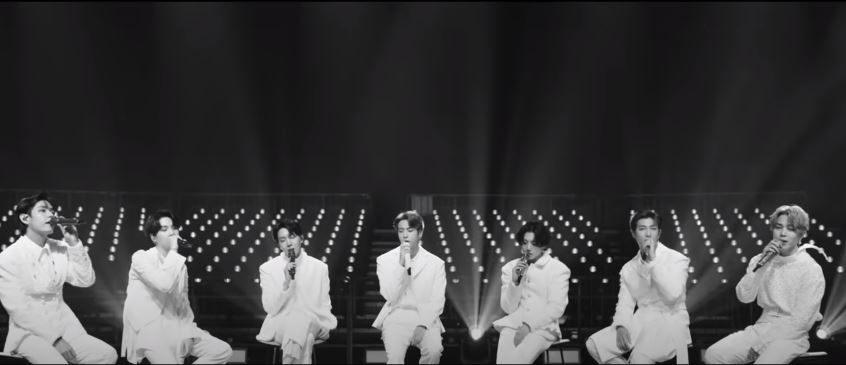From the previous shot Jin looks to his members (left to right). This is amazing if I'm getting this right. Because it's simultaneously a look to the past and a look to the future while being in the present. The monochrome for memories, the stage for present, and the fade into +