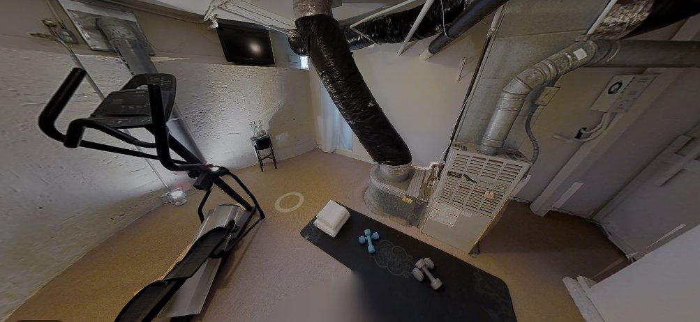 It leads to the basement furnace / HVAC, which for the purposes of this house listing decided to make it a depressing fitness room.