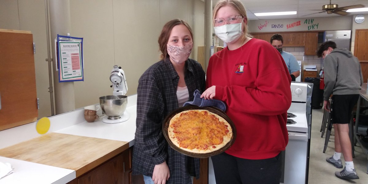 Culinary Essentials students using there red sauce for cheese pizza made from scratch.