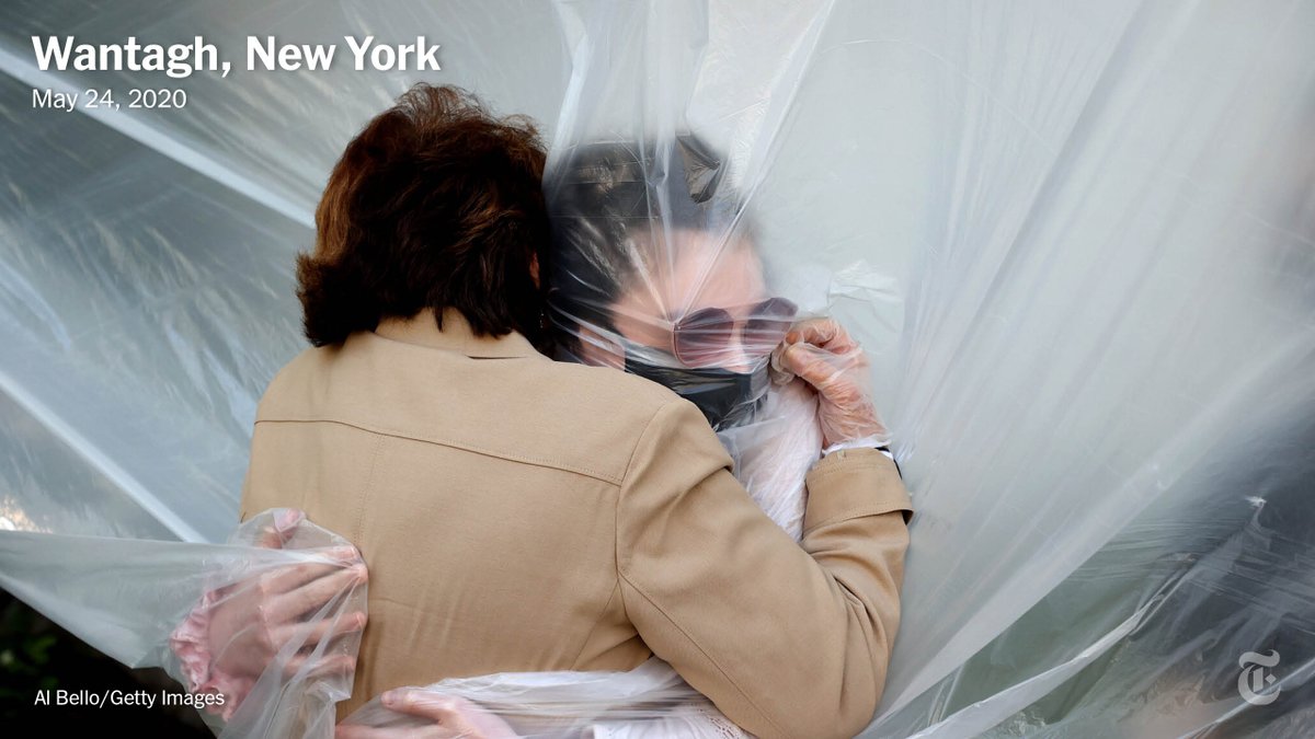 Al Bello, a sports photographer at Getty, shifted to covering Covid when the pandemic shut down most sports. In May, he photographed one family's elaborate system to allow grandparents to safely hug their grandchildren through a plastic dropcloth.  https://nyti.ms/2KbV1gg 