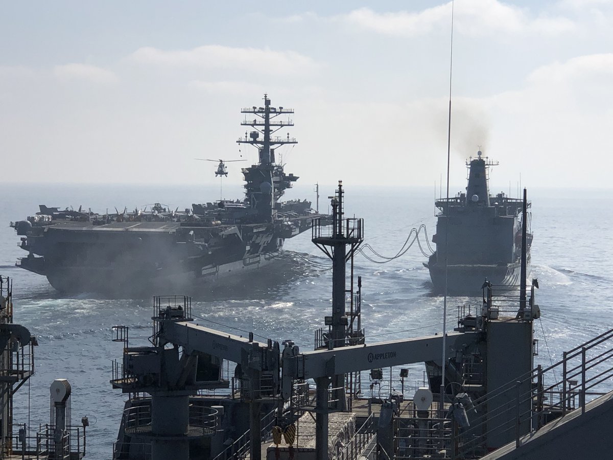 US5thFleet's tweet photo. Pilot house view from USNS Carl Brashear (T-AKE 7), as its SuperPuma helicopter delivers cargo onto the flight deck of the aircraft carrier USS Nimitz (CVN 68), while Nimitz receives fuel from USNS Yukon (T-AO 202) via connected replenishment.
#OperationalLogistics in action! https://t.co/76c6c5k26z
