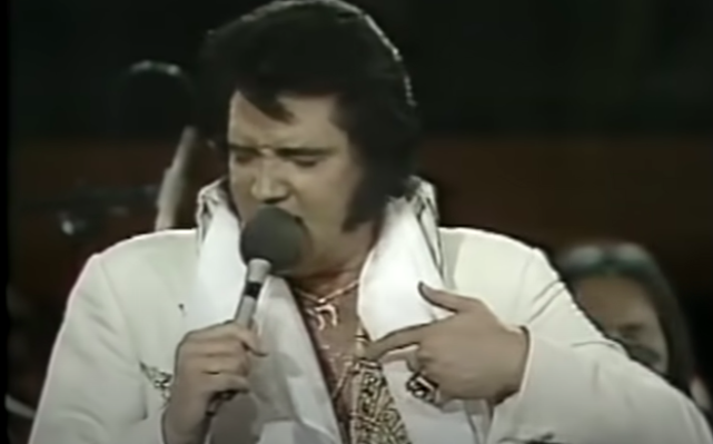 Why was Elvis Presley well known for his jewelry? And towards the end of  the 1970s, when Elvis did his concerts, why did he have band-aids on his  fingers with his jewelry? -