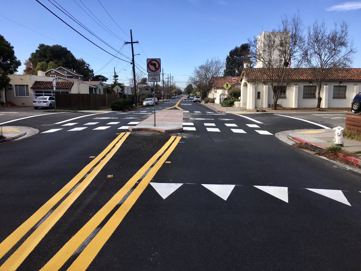 Berkeley’s first new bike blvd “diverter” in a while, along 9th St at Cedar, is... interesting. Very low profile due to the fire station access needs on the corner, so we’ll have to see how it works. Installed as part of routine paving on Cedar.  #TheSmoothening