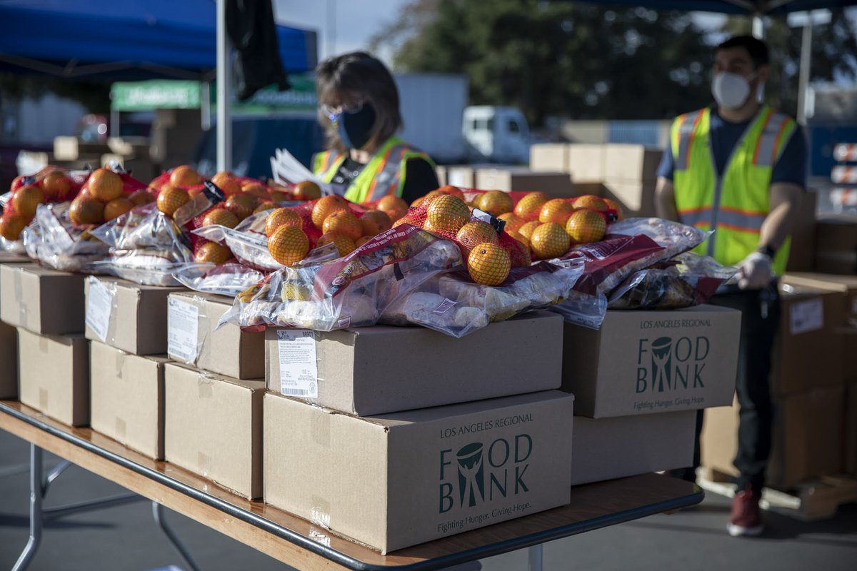 Los Angeles Regional Food Bank volunteers prep food kits for those in need at an emergency food drive-through distribution.